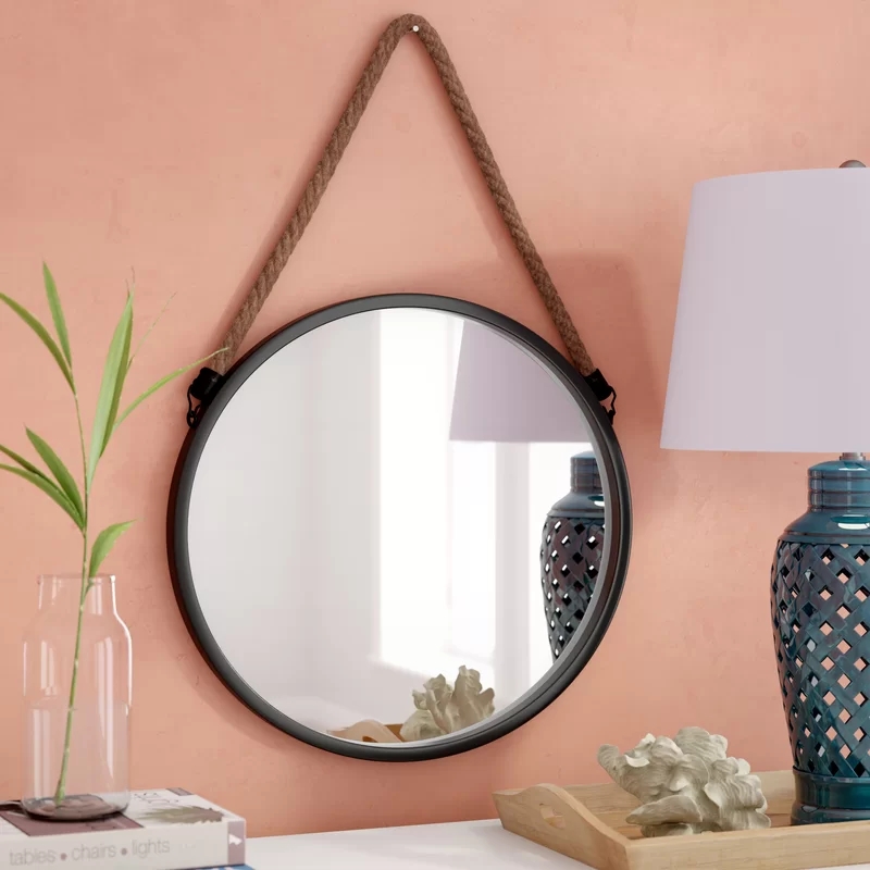 Black round metal wall mirror